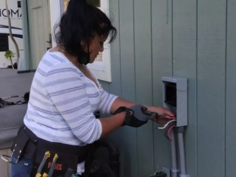 Licensed electrician wiring an exterior subpanel in Altus